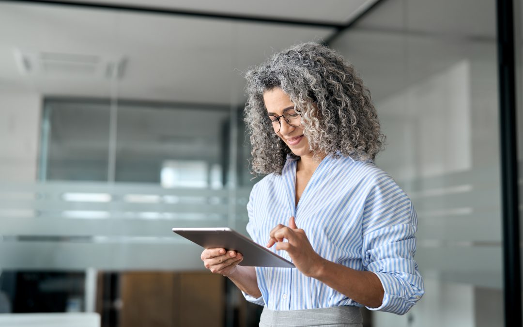 Older female, looking at a digital screen in hand